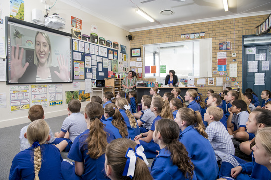 class room with a blonde haired women on screen